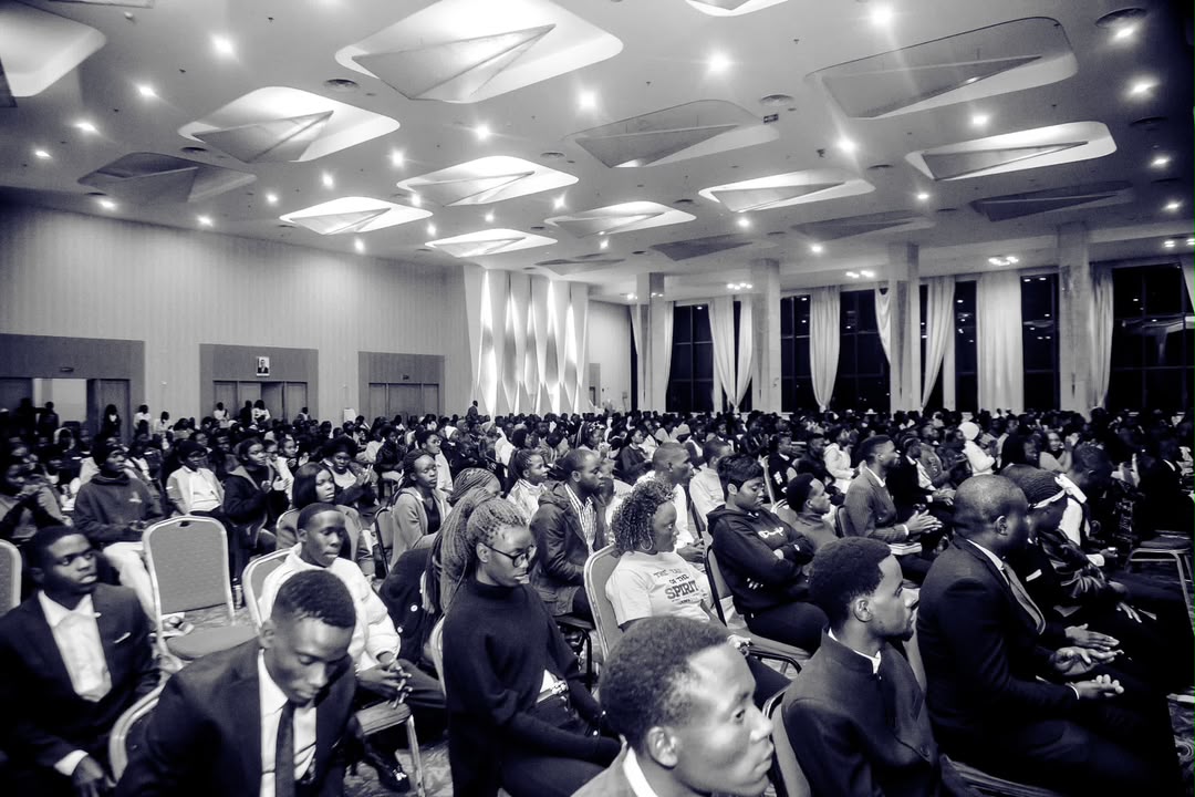 Black-and-white view of a packed auditorium