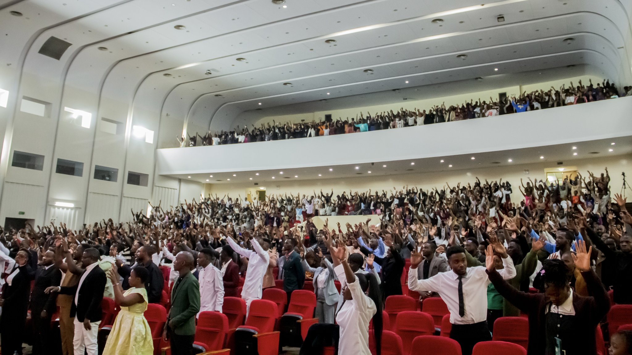 Congregation with hands raised in worship