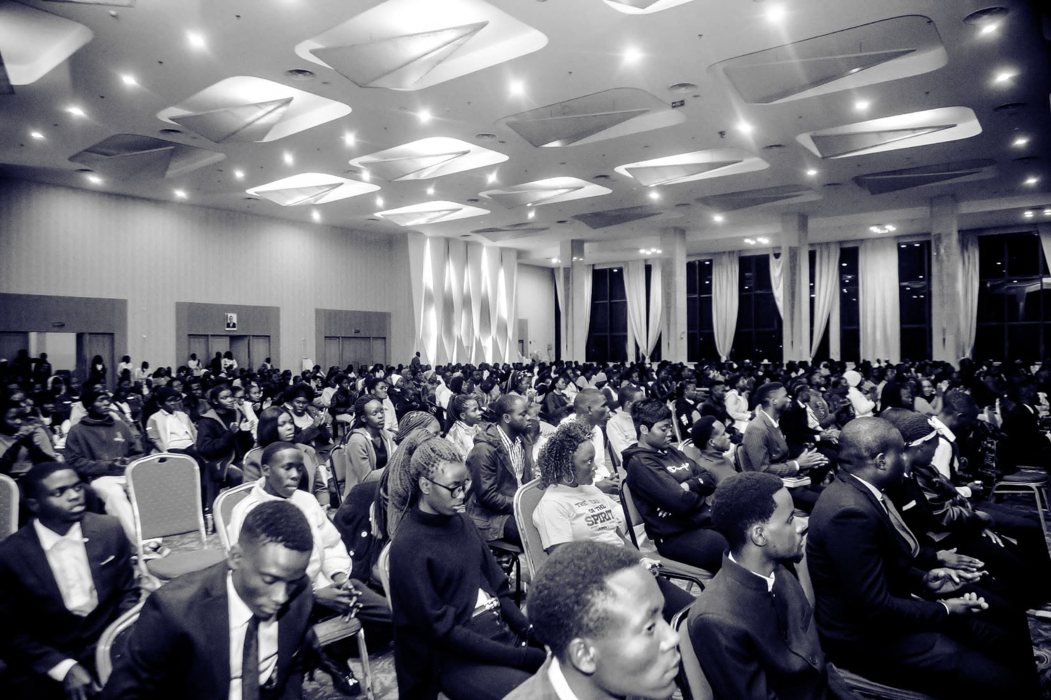 Wide black-and-white view of a full congregation